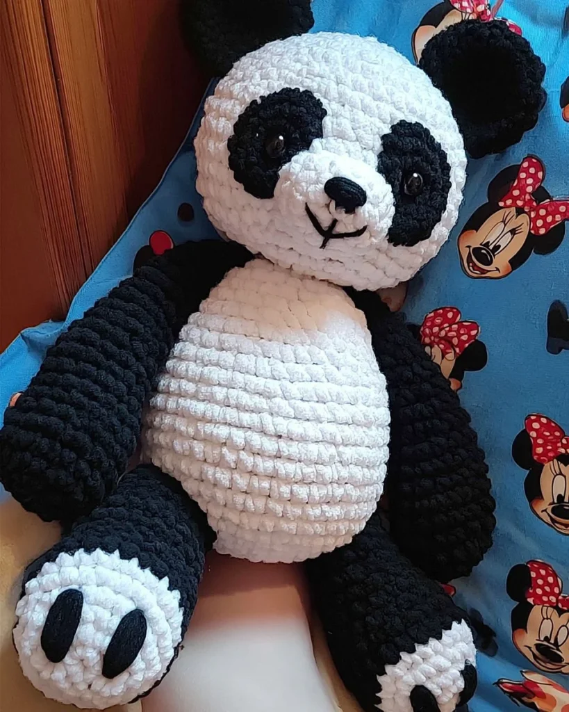 Giant amigurumi panda plush made using a free crochet pattern